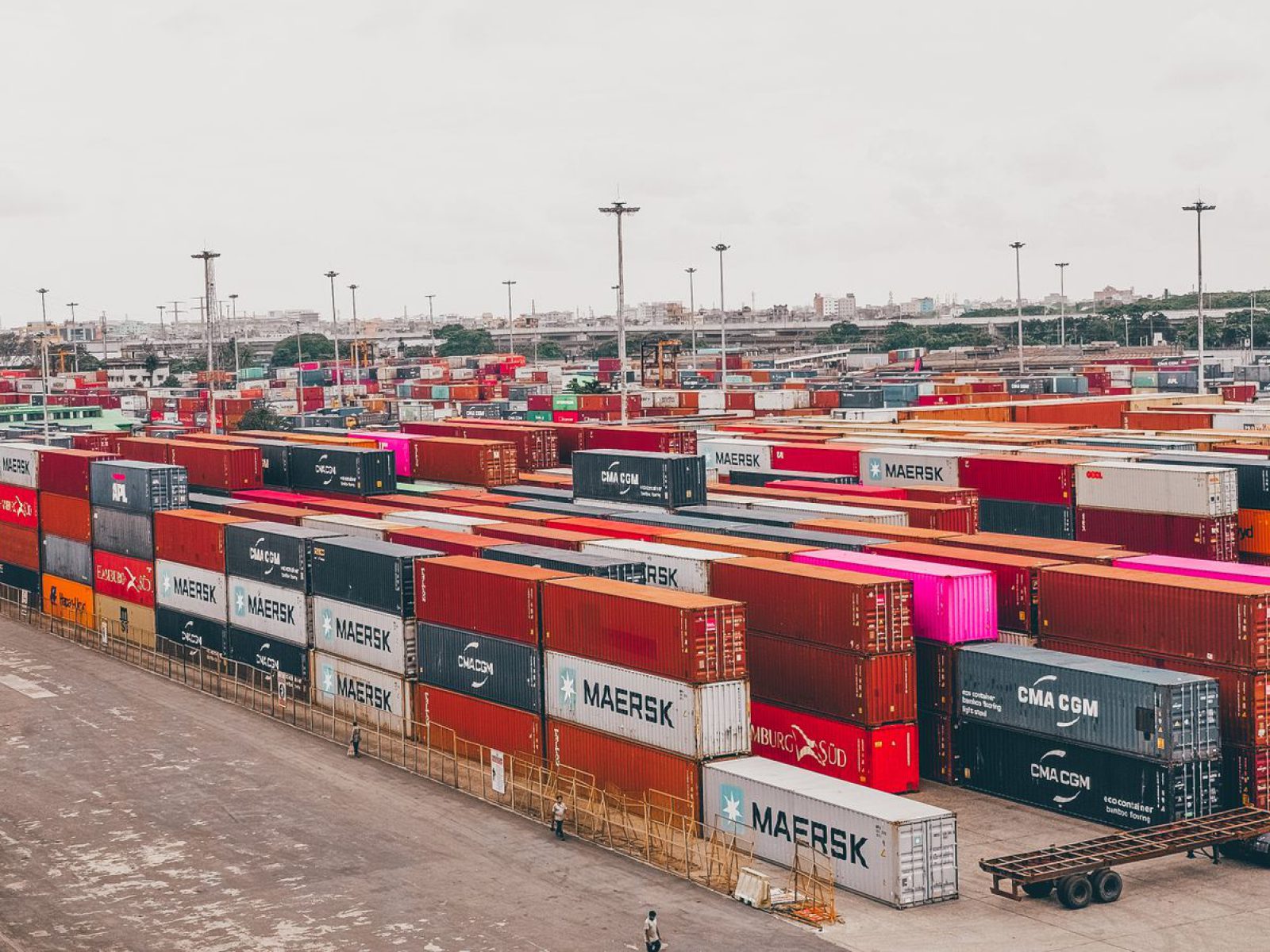 Colorful shipping containers stacked at a bustling port showcasing global trade.
