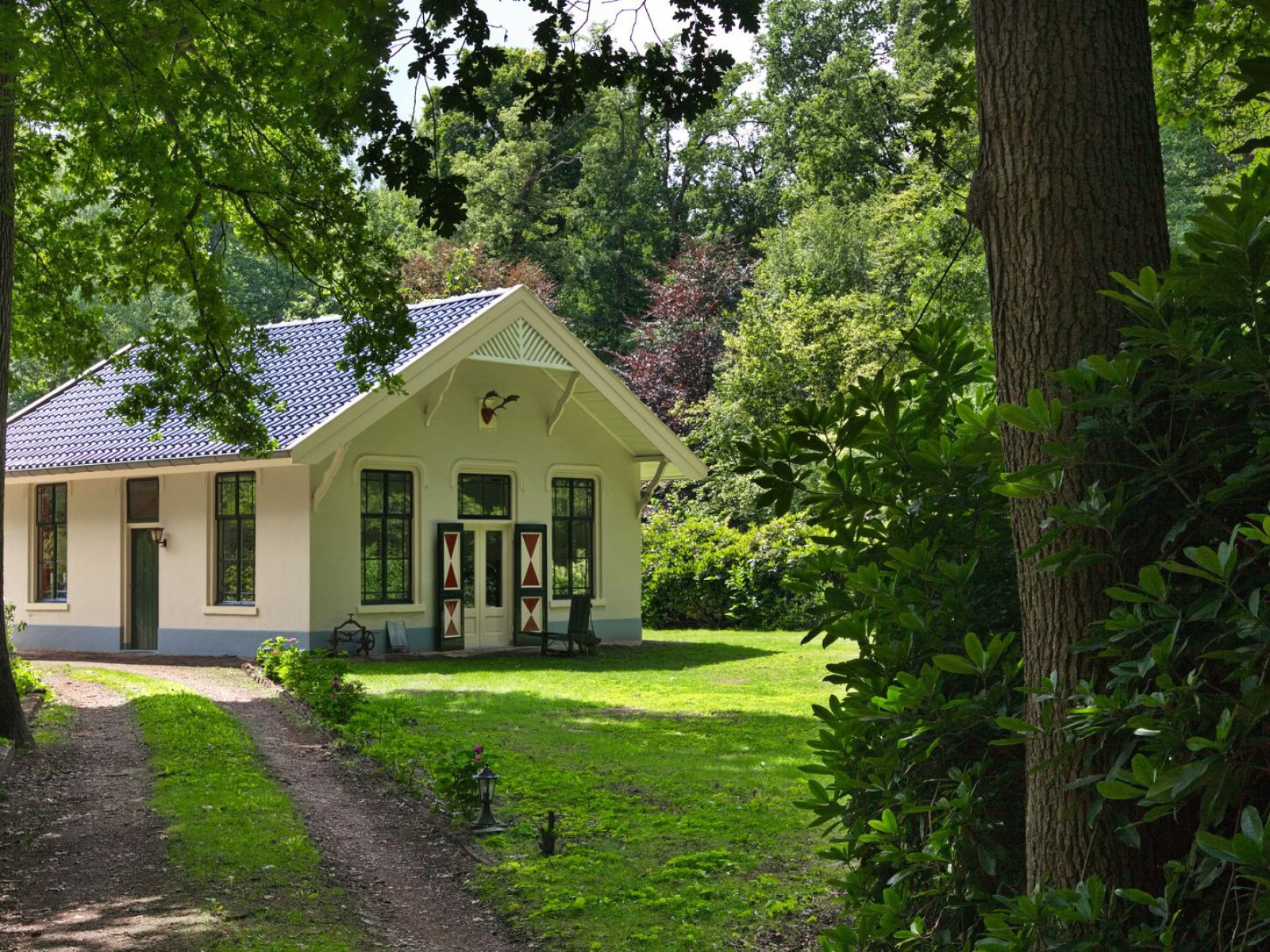 Cozy woodland cottage with traditional design in a vibrant green forest.